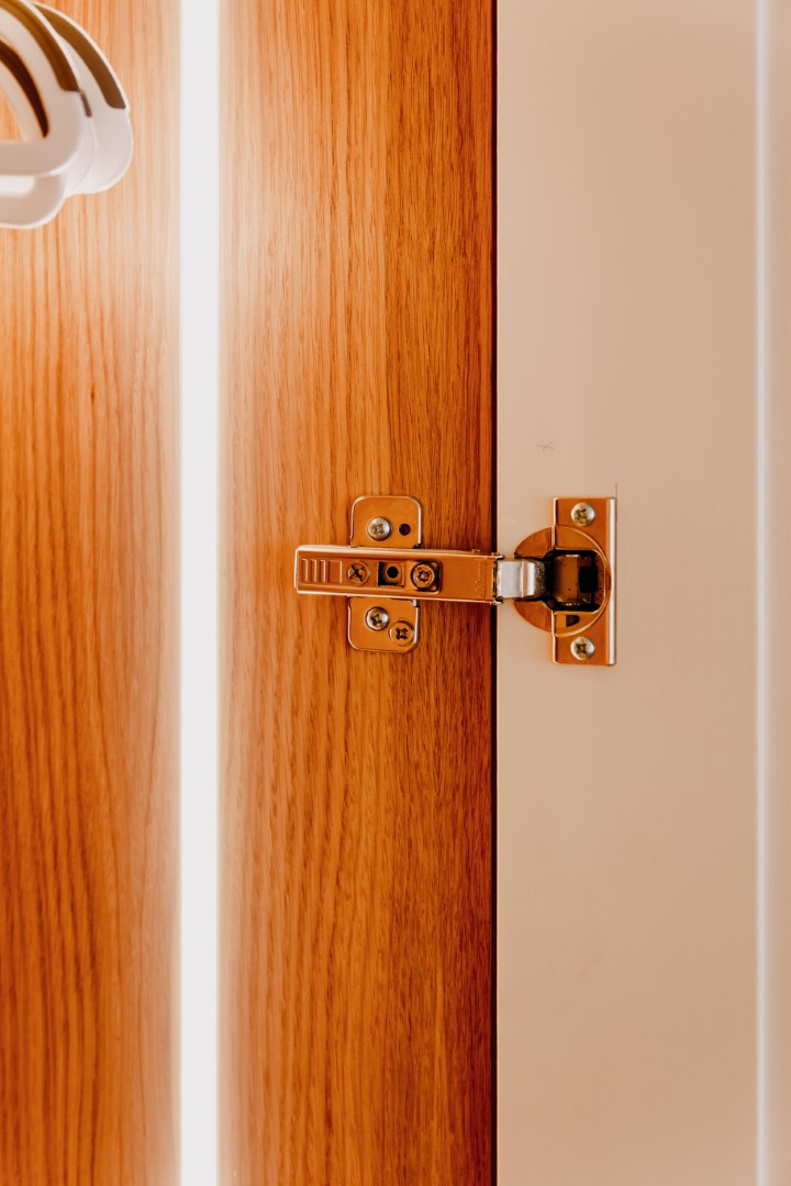 Close-up of a wooden door hinge.