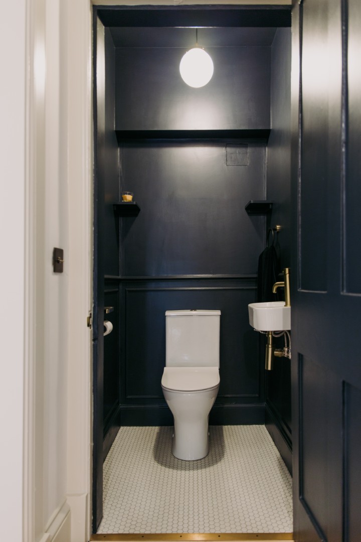 Stylish dark-painted small bathroom interior