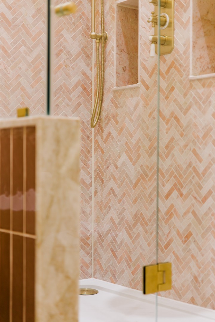 Elegant bathroom with herringbone tiles.