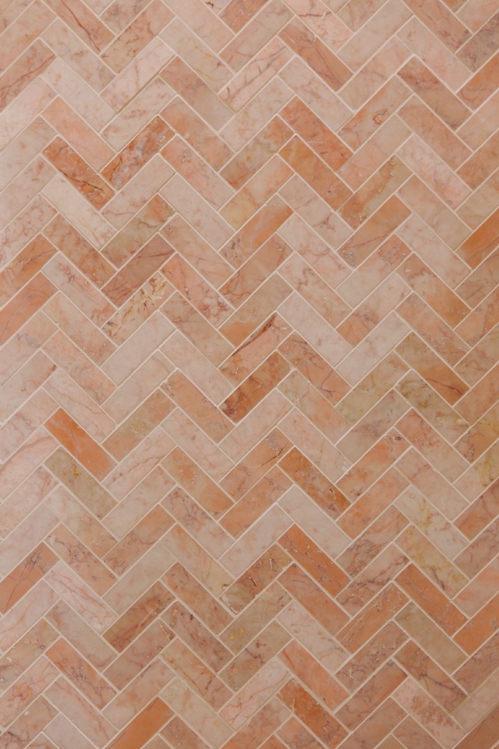 Herringbone patterned marble tile design.