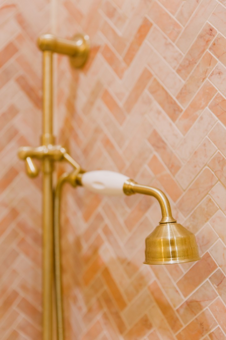 Elegant brass shower fixture against tiles