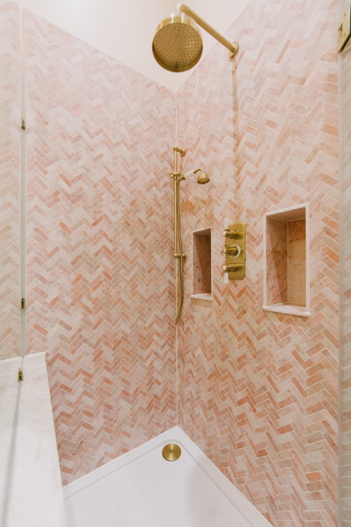 Stylish pink herringbone tiled shower