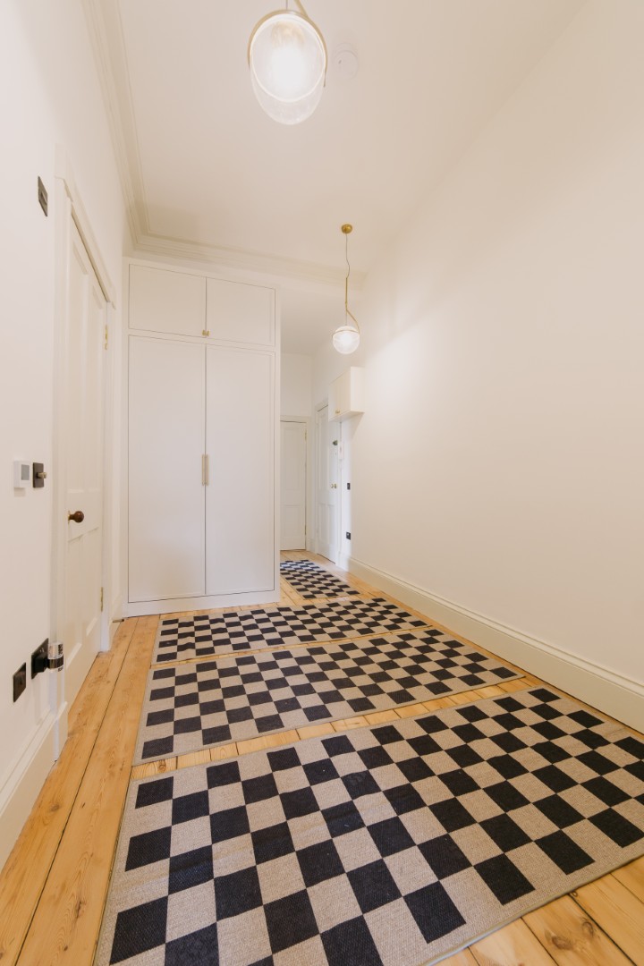 Stylish hallway with checkered flooring.