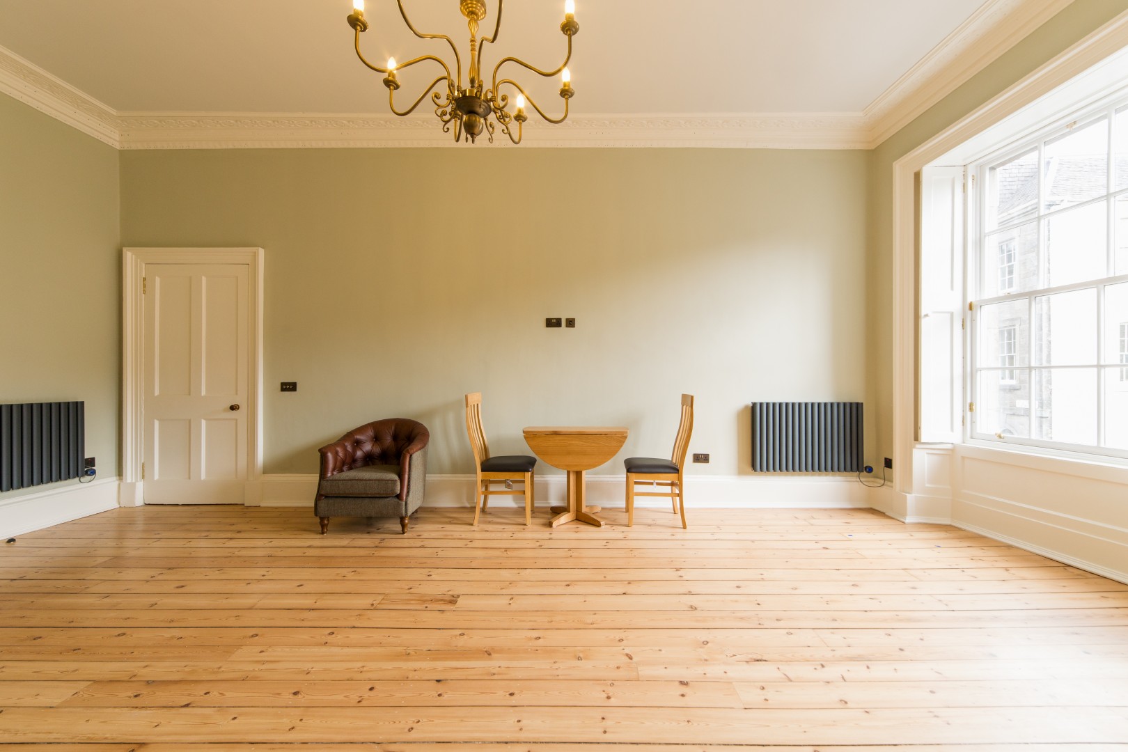 Spacious room with wooden flooring.