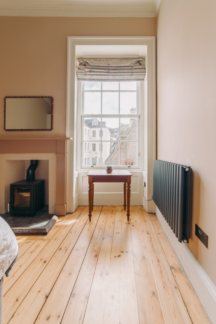Bright room with wooden flooring and window