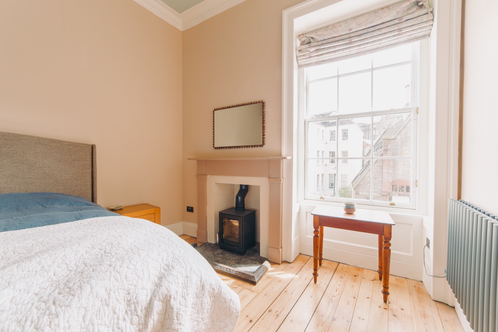 Bright bedroom with fireplace and window