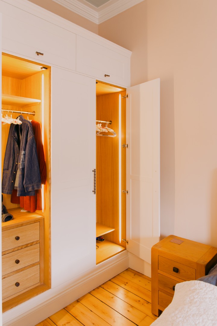 Stylish wardrobe with warm lighting.
